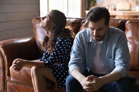 Young married couple going through relationship problems, divorce, Annoyed tired husband and wife keeping silence and ignore after arguing, quarrel, fighting. Family crisis, breakup, stress conceptの写真素材