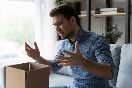 Unhappy man frustrated by wrong order online shopping or damaged package, bad delivery service,...