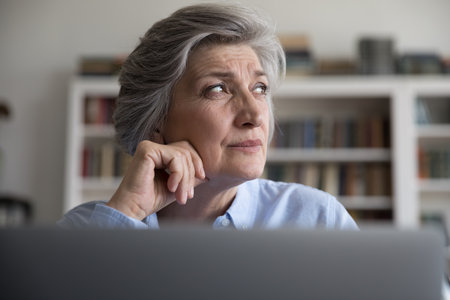 Head shot stressed middle aged businesswoman employee entrepreneur looking in distance, stuck with difficult task or considering problem solution, feeling frustrated working distantly at home office.の写真素材