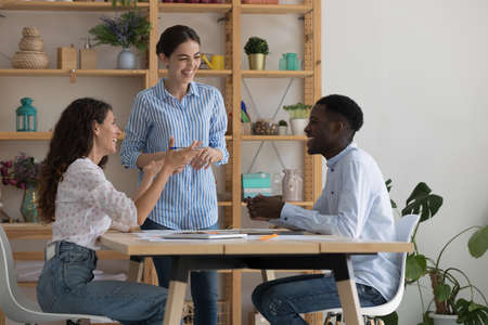 Happy excited diverse employees working on project, discussing creative funny ideas, brainstorming,...