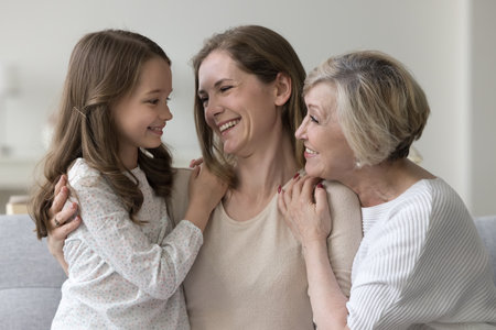 Lovely women hugging showing care feel unconditional love spend priceless time together at home, looking at each other with affection and warmth. Multigenerational family portrait, ties, understandingの写真素材