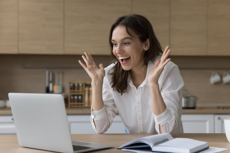 Cheery woman use notebook, check email, receive happy awesome surprising news, get new job or special commercial offer, notice about sell-out, celebrate professional or personal success. Victory, luckの写真素材