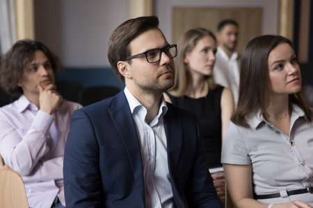 Group of businesspeople, entrepreneurs, office employees listening speech of trainer, participate in educational training, receive information, take part in seminar in conference room. Workshop eventの写真素材