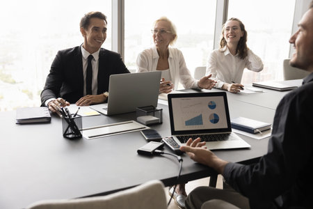 Cheerful diverse HR business team talking to candidate at job interview, laughing, having fun....