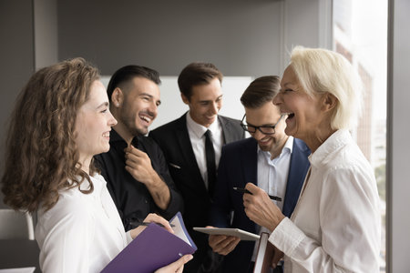 Cheerful business colleagues women talking, enjoying funny conversation, laughing on work break....