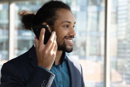 Positive emotions. Smiling confident millennial african american businessman listen to successful...