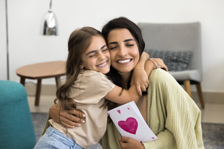 Happy excited mommy and cheerful child girl celebrating mothers day, birthday, 8 march, holding...