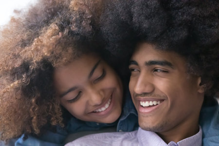 Close up portrait, cute African teenager loving couple. Beautiful young curly haired girlfriend...