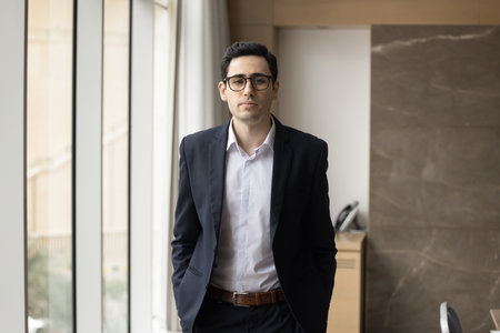 Portrait of young professional man, company staff member, executive manager dressed in formal suit...