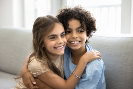 Close up photo of two adorable kids, friendly twins 7 years old, embrace each other joyfully,...