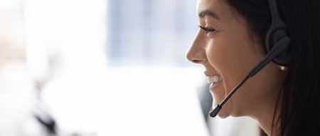 Facial banner portrait of positive successful telephone sales agent talking to customer on audio...
