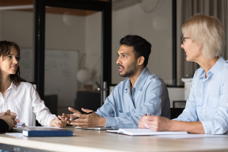 Business professional man, strong leader leading board meeting, executive people talk in a boardroom. Manager discussing project with diverse partner team. Office management working, finding solutionsの写真素材