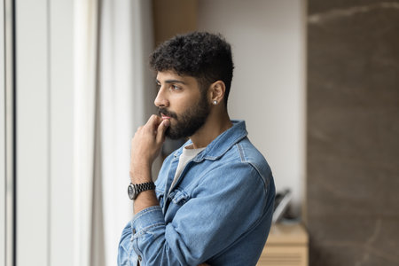 Lost in thoughts. Thoughtful serious businessman in casual shirt look at distance in office window...
