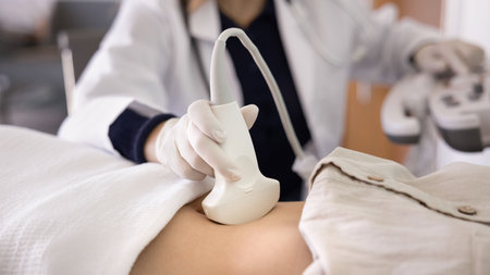 Hand of doctor woman using modern sonography diagnostic technology, ultrasound scanner for abdominal...