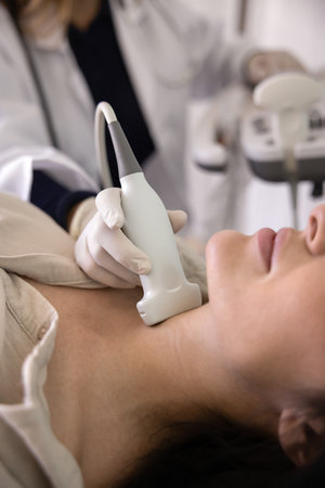 Close up cropped shot of female patient visiting doctor for ultrasound diagnostic checkup, examining...