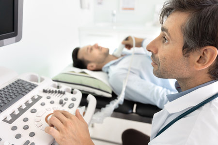 Sonologist at work. Close up portrait serious mature male doctor radiologist medical imaging expert...