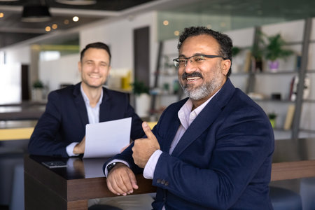 Happy aged Indian businessman, client showing thumps up gesture at camera, recommending quality...