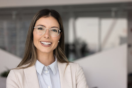 Happy successful beautiful Hispanic business leader woman in elegant eyeglasses posing for...