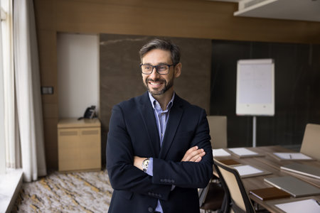 Business leader. Portrait of happy confident millennial businessman in formal suit company ceo...