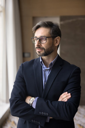 Strategy of success. Vertical photo thoughtful serious young adult businessman in formal wear look aside with confidence think on business development plan marketing growth meet professional challengeの写真素材