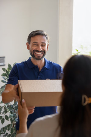 Please take your dispatch. Cheerful middle aged man professional courier delivery service worker...