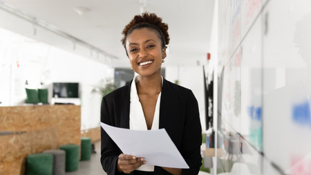 Confident young professional. Portrait happy young businesswoman wearing formal suit standing with...