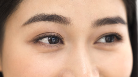 Cropped close up photo of young 25s Chinese womans eyes looking away with contented expression, promoting vision care, optical clinics, lenses brands and eyecare health services. Eyesight correctionの写真素材