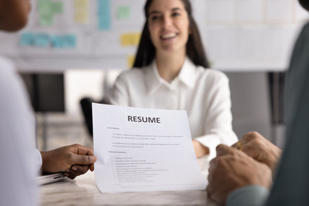 Job interview starting from resume. Close up professional team two diverse recruiters career...