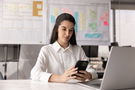 Office multitasking. Confident busy young woman corporate employee sales manager working on...