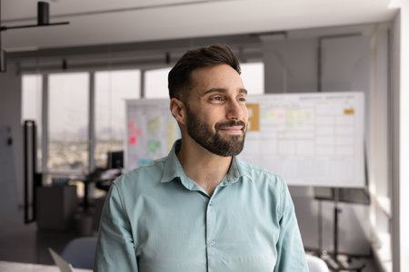 Creative vision. Headshot portrait forward thinking confident young businessman stand in modern...