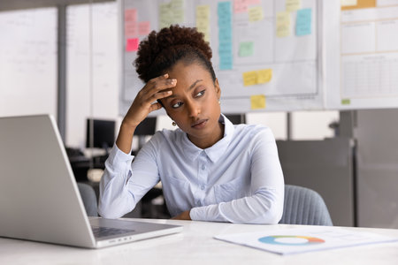 Mental block. Tired unhappy young woman corporate strategist accountant sit by laptop in office look aside from screen unable to solve difficult problem feel creative crisis stress lack of motivationの写真素材