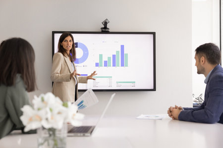 Group of stakeholders meeting for presentation, discussing product sales growth. Female...