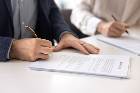 Hand of businessman signing contract on meeting with partner, investor, project seller or buyer,...