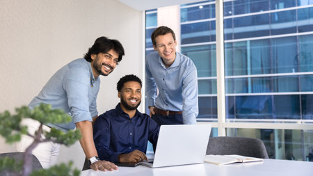 Successful business professionals. Portrait three diverse men project developers team distracted from computer office work look forward visualize future startup success enjoy collaboration. Copy spaceの写真素材