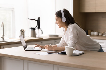 Easy comfortable distance learning. Smiling confident young female remote student in wireless...