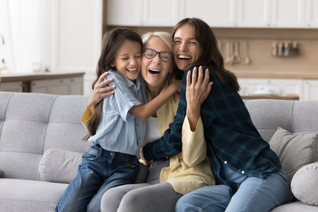 In tight and warm cuddles. Overjoyed excited aged lady laugh happily in loving embraces of adult...
