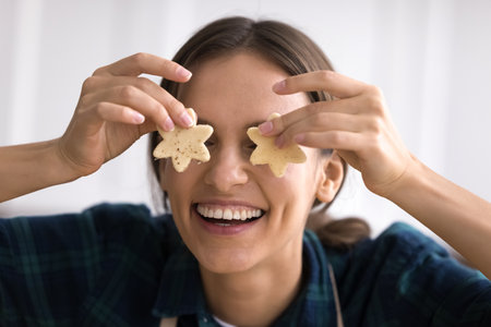 Playful cooking mood. Head shot portrait cute millennial woman domestic baker look at camera with...