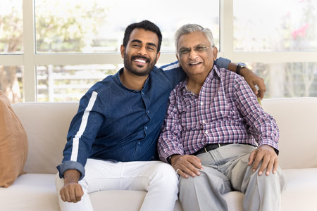 Multigenerational family portrait, understanding and ties. Cheery grey-haired man embracing his...
