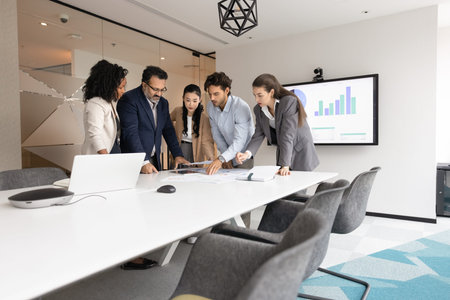 Project planning. Professional multiethnic business team ahead with mature man leader stand around...