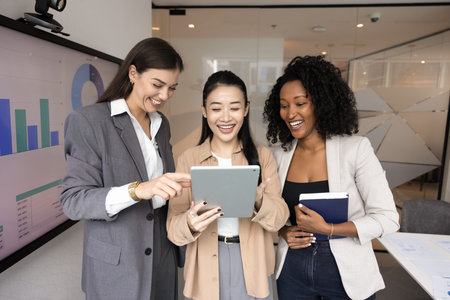 Professional friendship and successful work. Multiethnic group of 3 young businesswomen having fun...