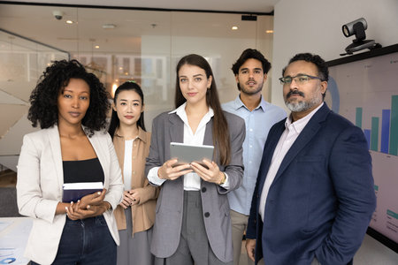 Experts in business. Group portrait serious confident multiethnic businesspeople agency department...