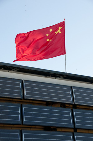Solar plates at home with the flag of Chinaの写真素材