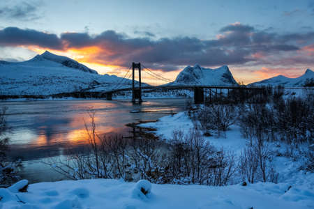 Bridge over a Norwegian fjord during a sunrise in winter