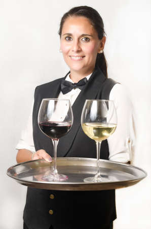 White waitress carrying a tray with red wine and white wine