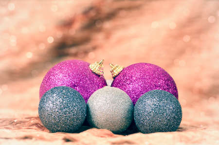Christmas decorations purple and silver, with golden background blur and glareの写真素材