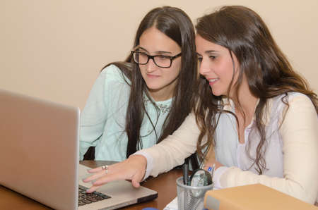 Young women using a computer while Smiling