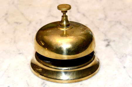 hotel bell in the foreground on reception tableの写真素材
