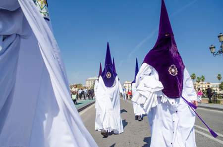 SEVILLE. SPAIN - APRIL 13: Penitents of the brotherhood of La Estrella In their procession by...