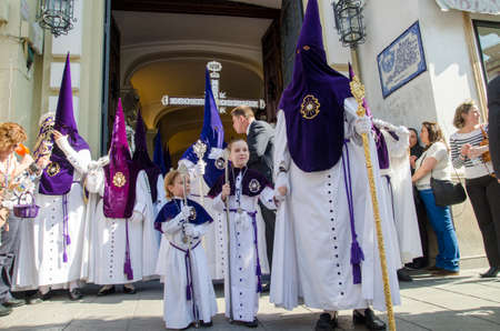 SEVILLE. SPAIN - APRIL 13: Penitents of the brotherhood of "La Estrella" In their procession by Seville, In Holy week on april 13, 2014 in seville.のeditorial素材