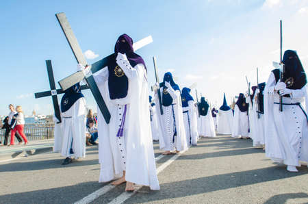 SEVILLE. SPAIN - APRIL 13: Penitents of the brotherhood of La Estrella In their procession by...